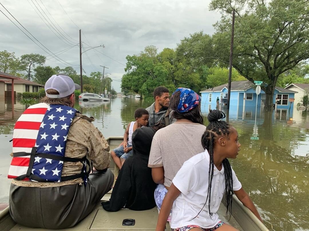 Disaster relief — Ryan Nichols delivering supplies to a flooded community