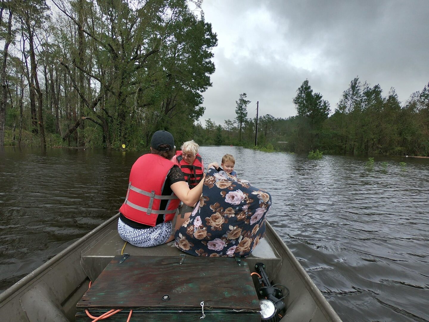 Ryan Nichols carrying flood victims to safety during a Texas hurricane rescue